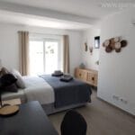 Luxury master bedroom with ensuite bathroom and desk, dayligth and view through groundfloor's quintal at Casa da Torre