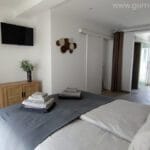 Luxury master bedroom with ensuite bathroom and desk, dayligth and view through connected terrace at Casa da Torre