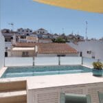 Casa da Torre's rooftop pool with Tavira's outskirts in the background