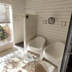 View from living area towards covered terrace with outdoor shower for rinsing after a day at the beaches of Terra Estreita or Praia do Barril, easily accessibel from Casinha Secreta